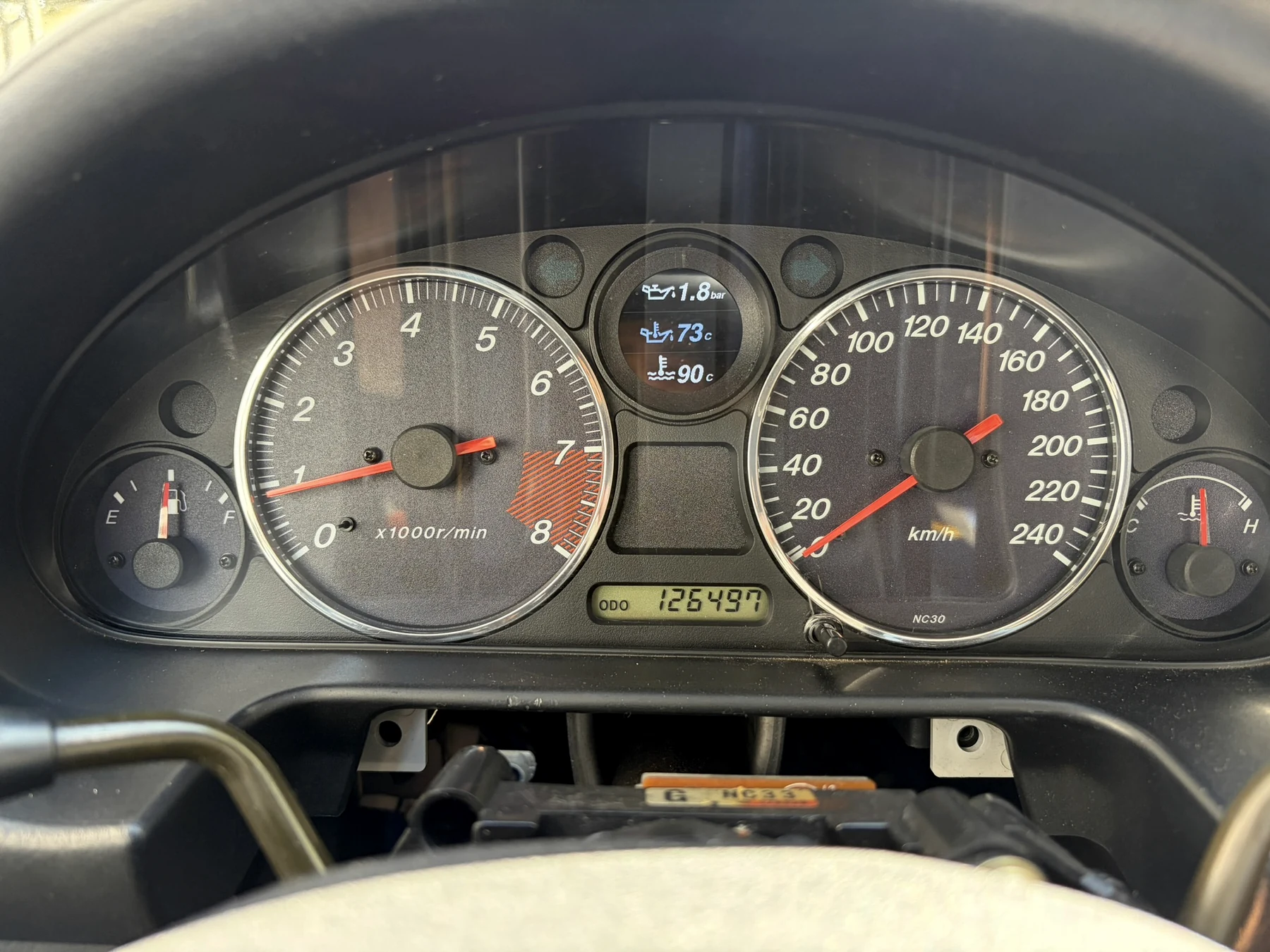 Real close-up of the Levo Gauge prototype installed in an MX-5 NB instrument cluster